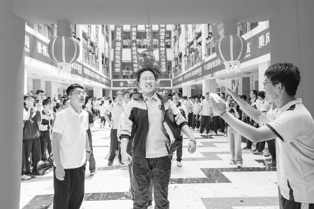           学子们头顶“高粽”，笑迎挑战。 本报记者 胡远嘉 摄        